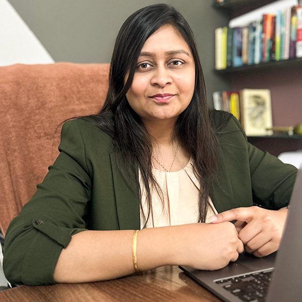 Shiwali Ratan Mishra working at her laptop in office space